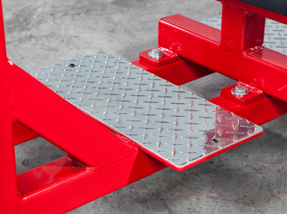 Red metal platform jack on a concrete floor
